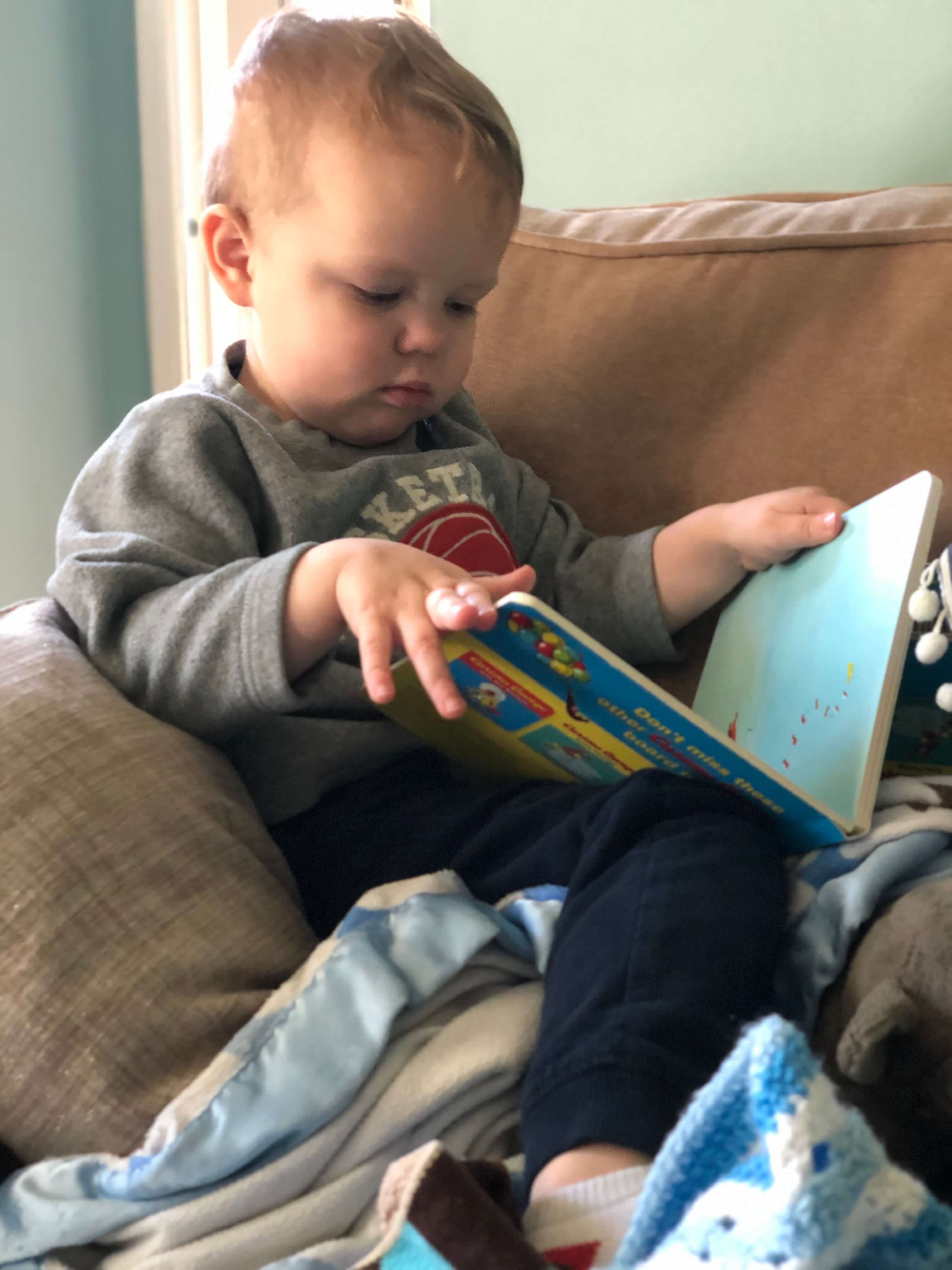 toddler boy reading book